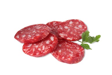 Pieces of delicious dry cured sausage and parsley isolated on white