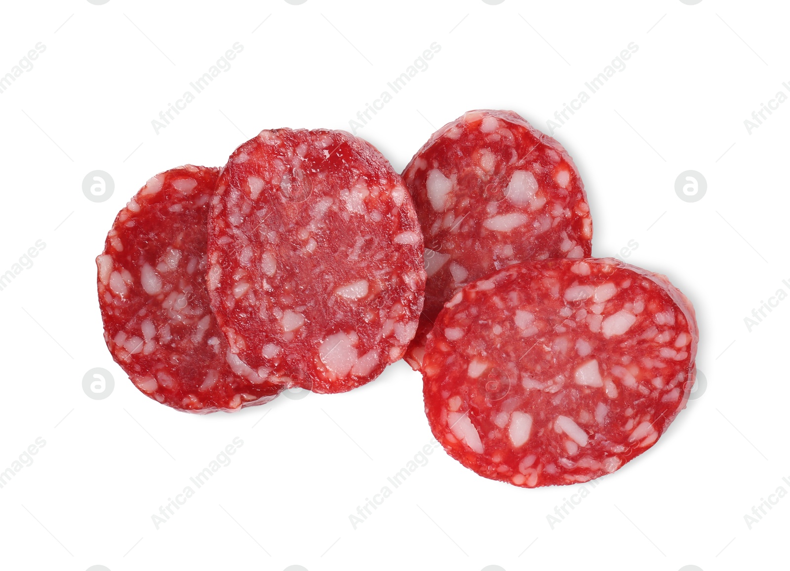 Photo of Pieces of delicious dry cured sausage isolated on white, top view