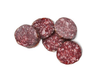 Photo of Pieces of delicious dry cured sausage isolated on white, top view