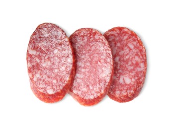 Pieces of delicious smoked sausage isolated on white, top view