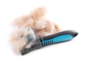 Photo of Grooming brush and pile of pet's hair isolated on white