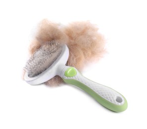 Photo of Grooming brush and pile of pet's hair isolated on white