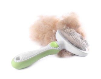 Photo of Grooming brush and pile of pet's hair isolated on white