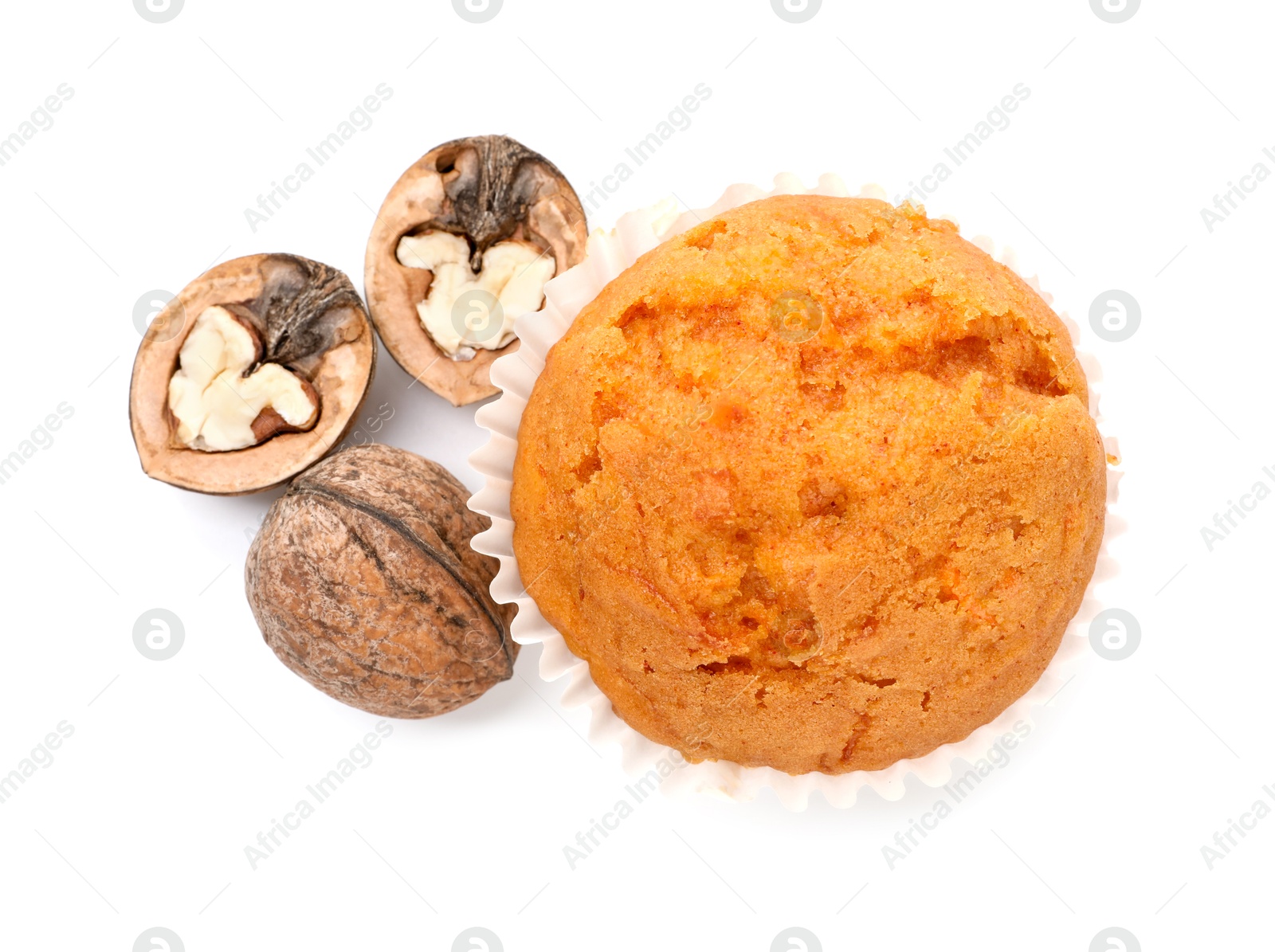 Photo of Tasty sweet carrot muffin and walnuts isolated on white, top view