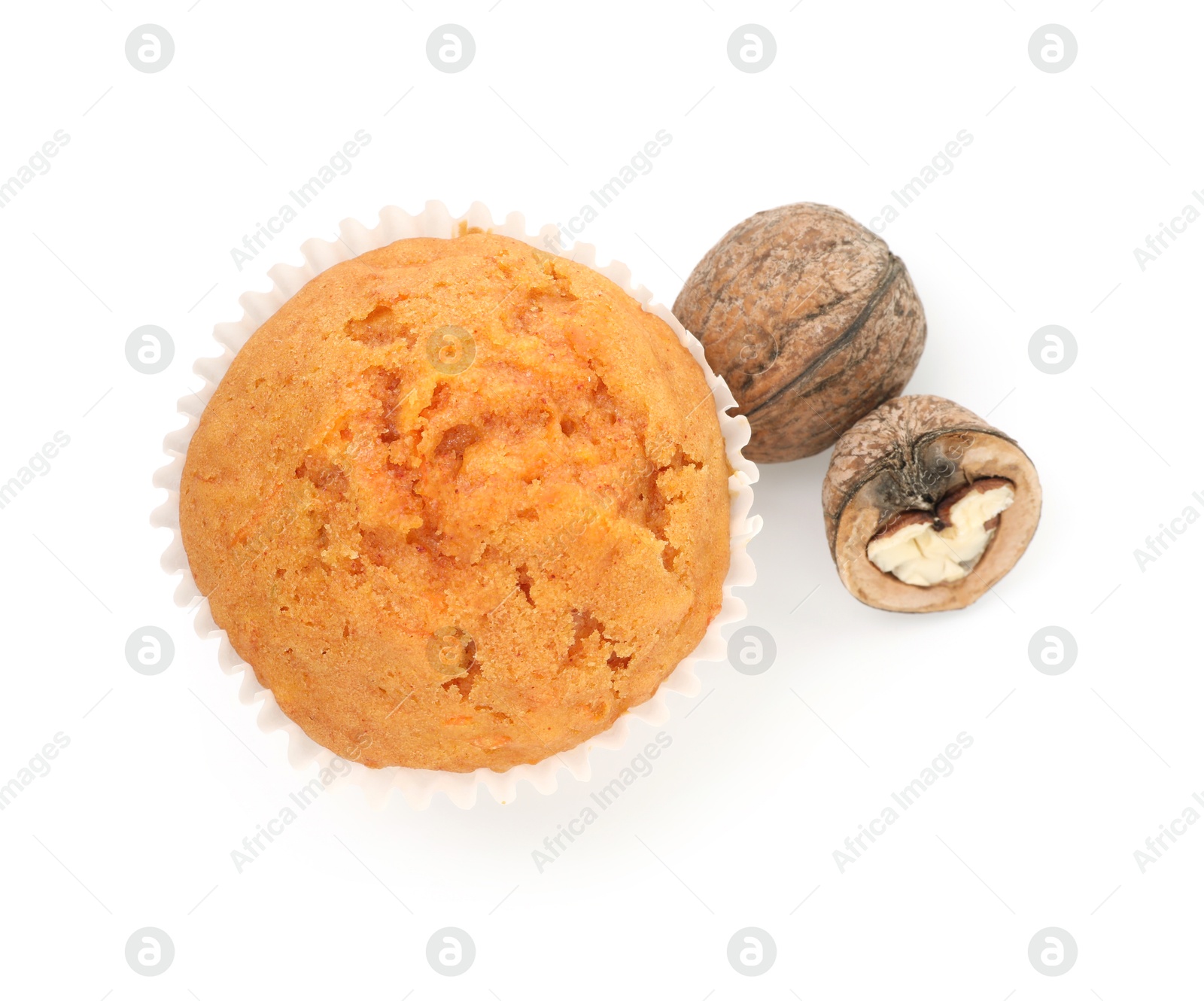 Photo of Tasty sweet carrot muffin and walnuts isolated on white, top view