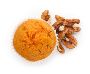 Photo of Tasty sweet carrot muffin and walnuts isolated on white, top view