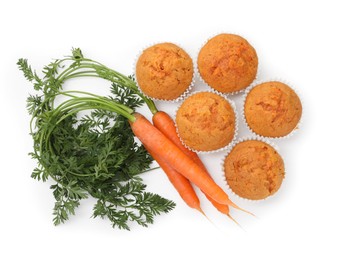 Photo of Tasty carrot muffins and fresh vegetables isolated on white, top view