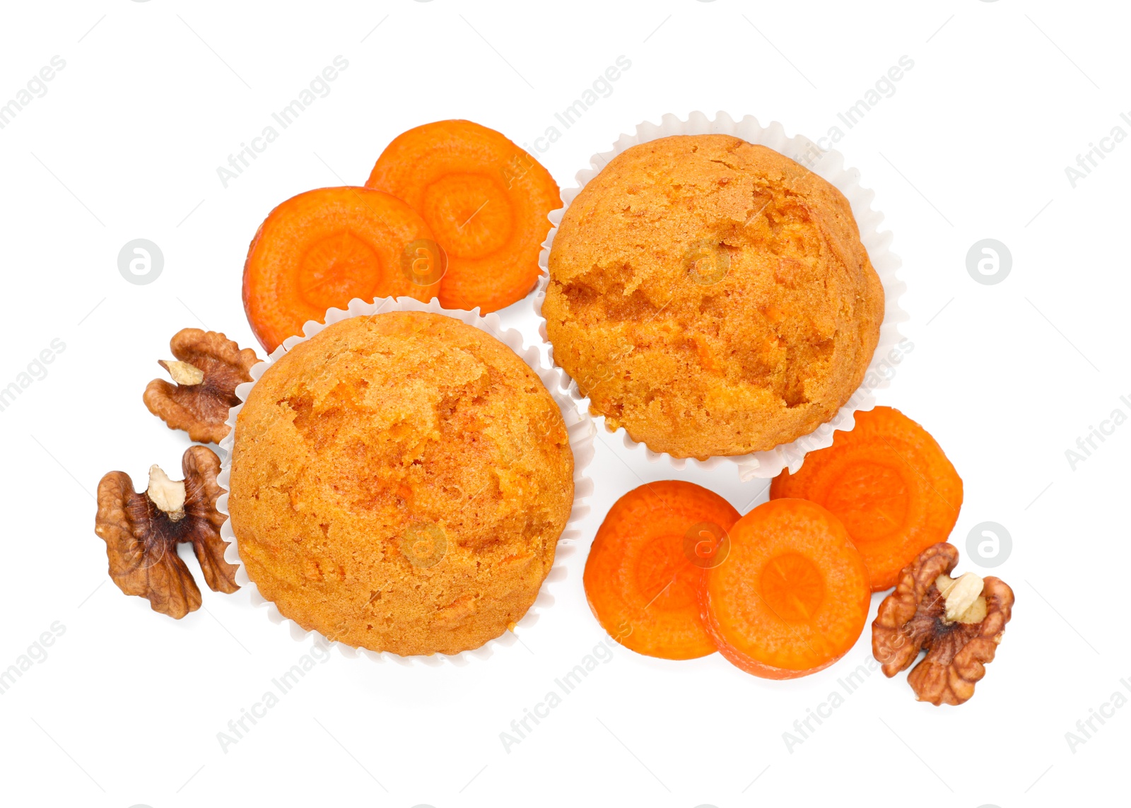 Photo of Tasty carrot muffins, walnuts and cut vegetable isolated on white, top view