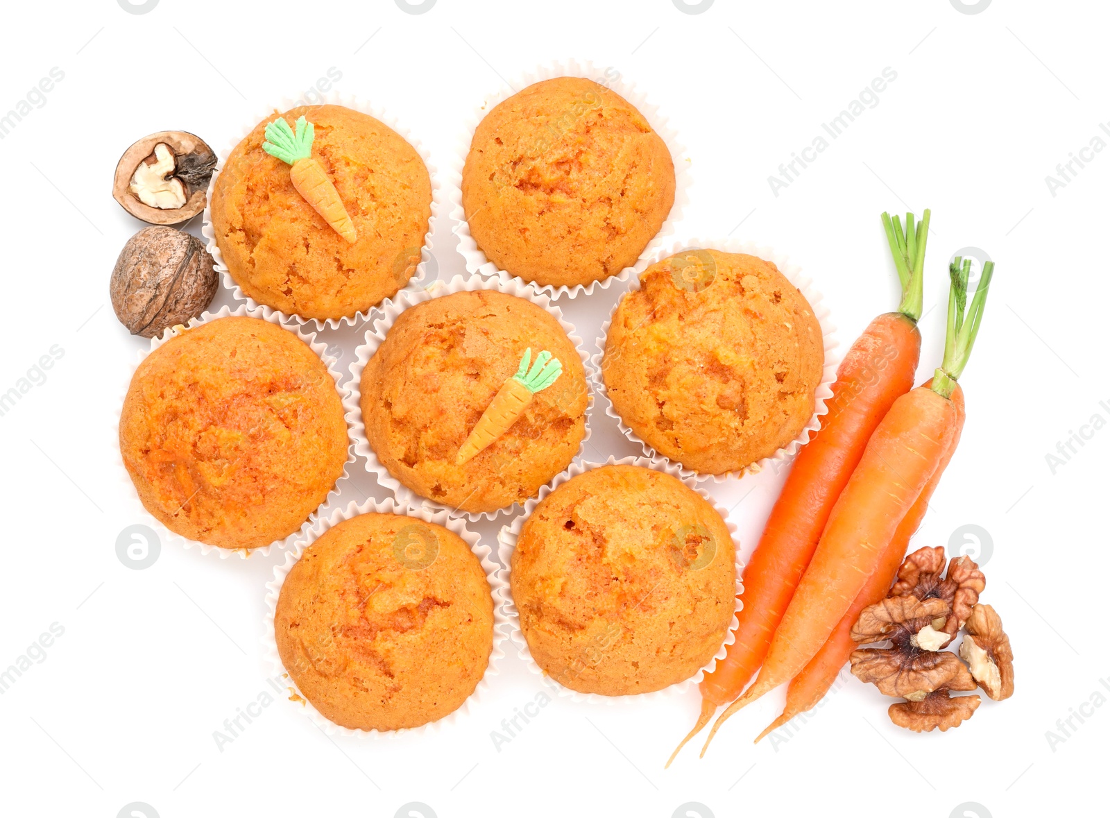 Photo of Tasty carrot muffins, walnuts and fresh vegetables isolated on white, top view