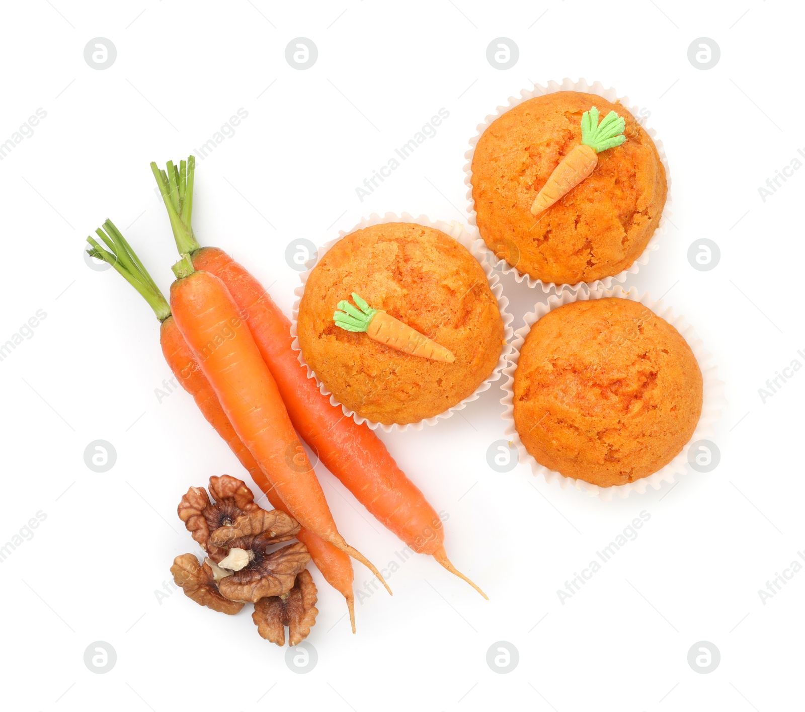 Photo of Tasty carrot muffins, walnuts and fresh vegetables isolated on white, top view