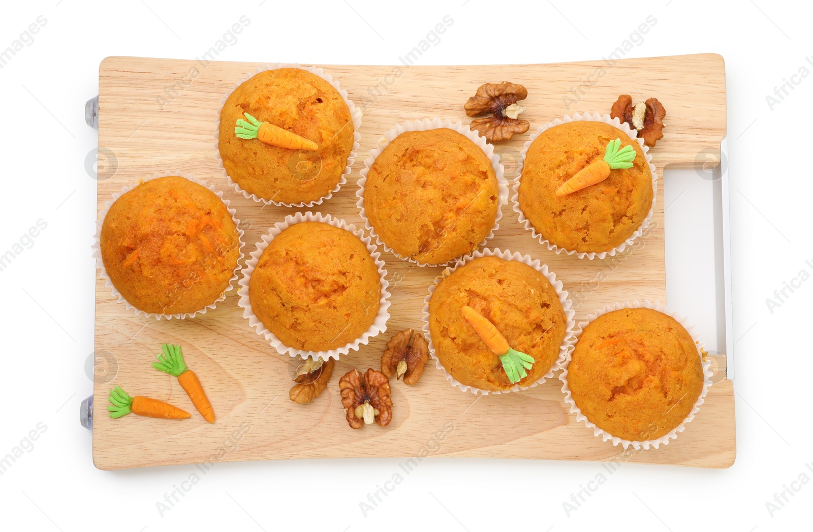 Photo of Tasty carrot muffins and walnuts isolated on white, top view