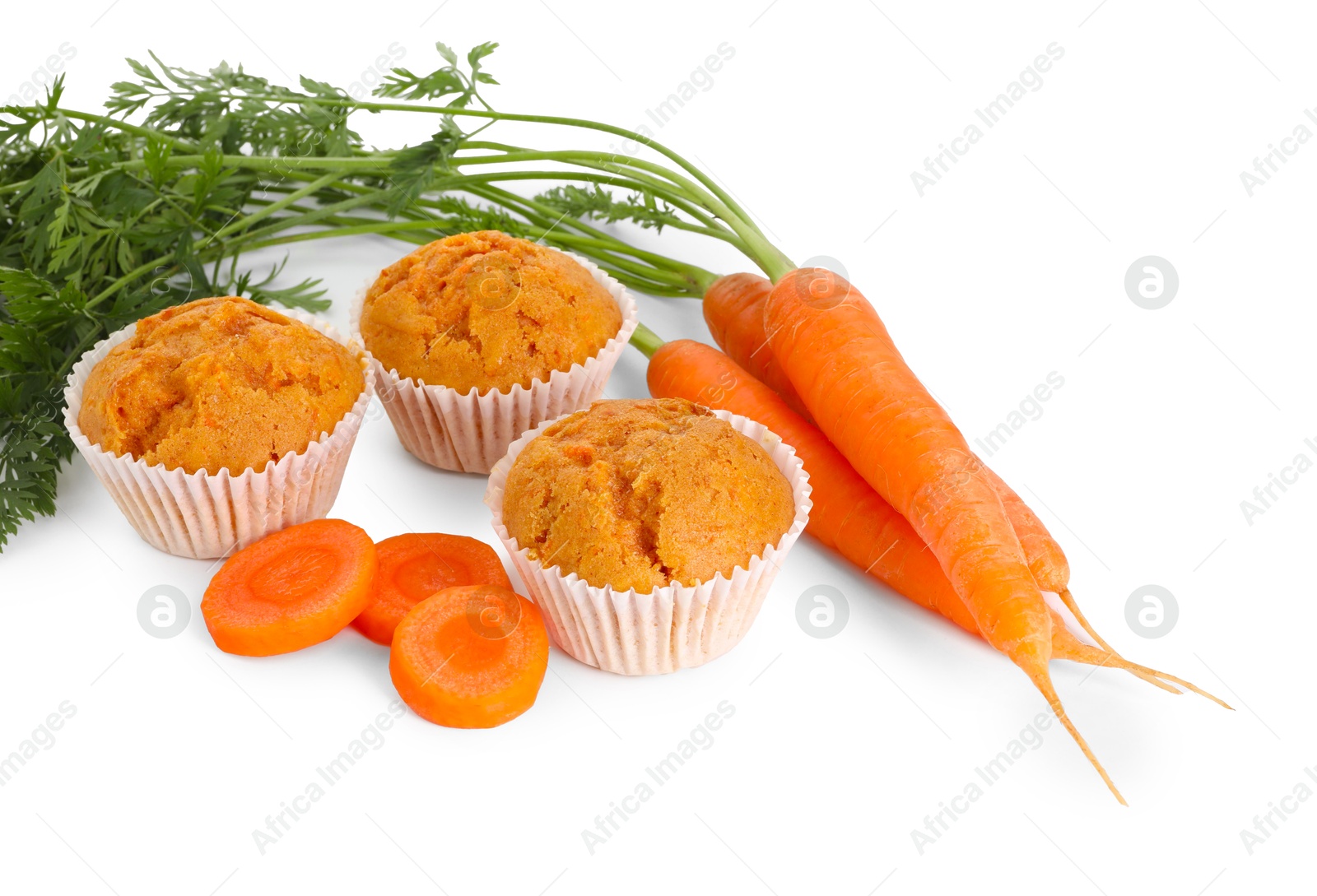 Photo of Tasty carrot muffins and fresh vegetables isolated on white