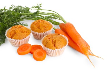 Photo of Tasty carrot muffins and fresh vegetables isolated on white