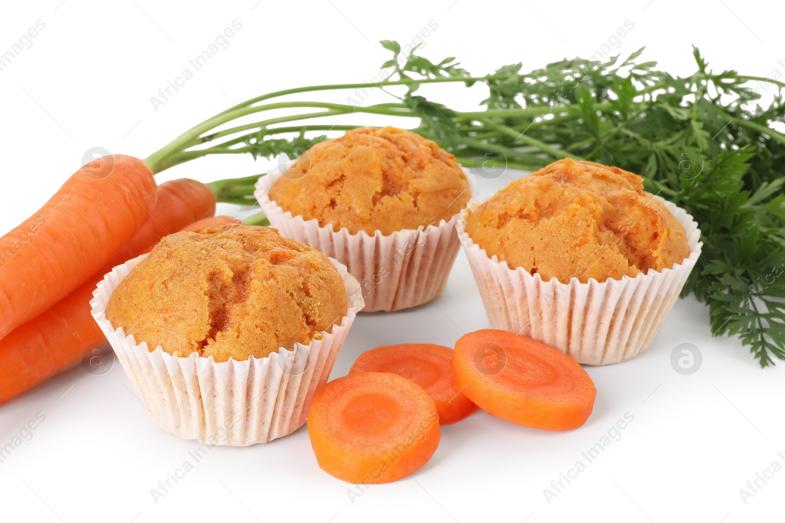 Photo of Tasty carrot muffins and fresh vegetables isolated on white