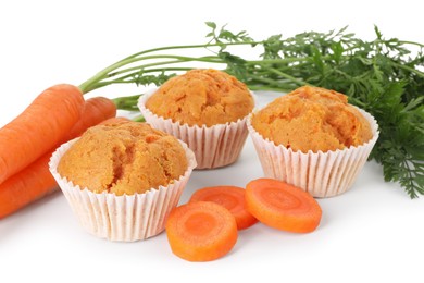 Photo of Tasty carrot muffins and fresh vegetables isolated on white