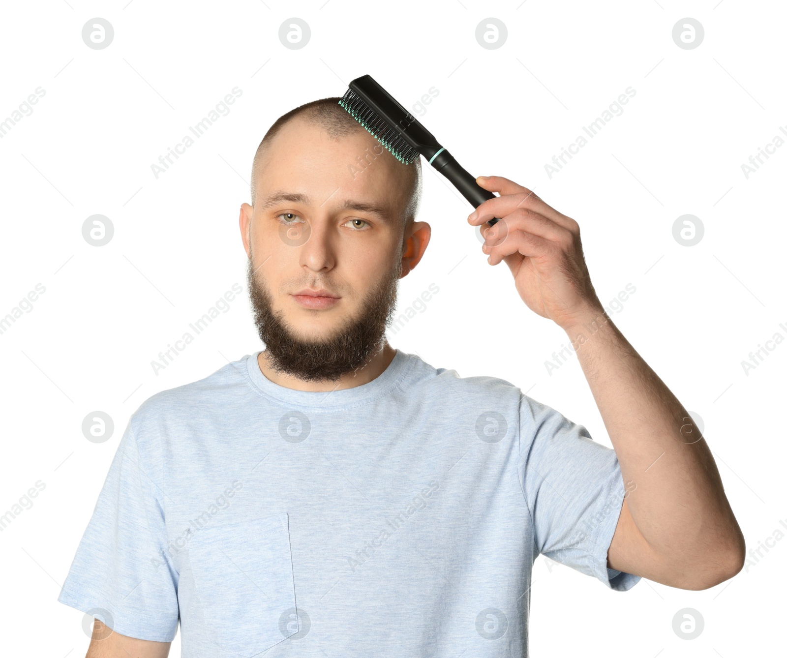 Baldness problem. Man brushing his hair on white background Photo of Baldness problem. Man brushing his hair on white background