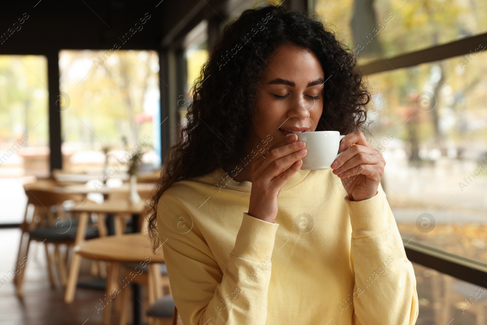 Photo of Woman enjoying her aromatic coffee in cafe