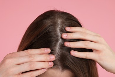 Photo of Girl with hair loss problem on pink background, closeup