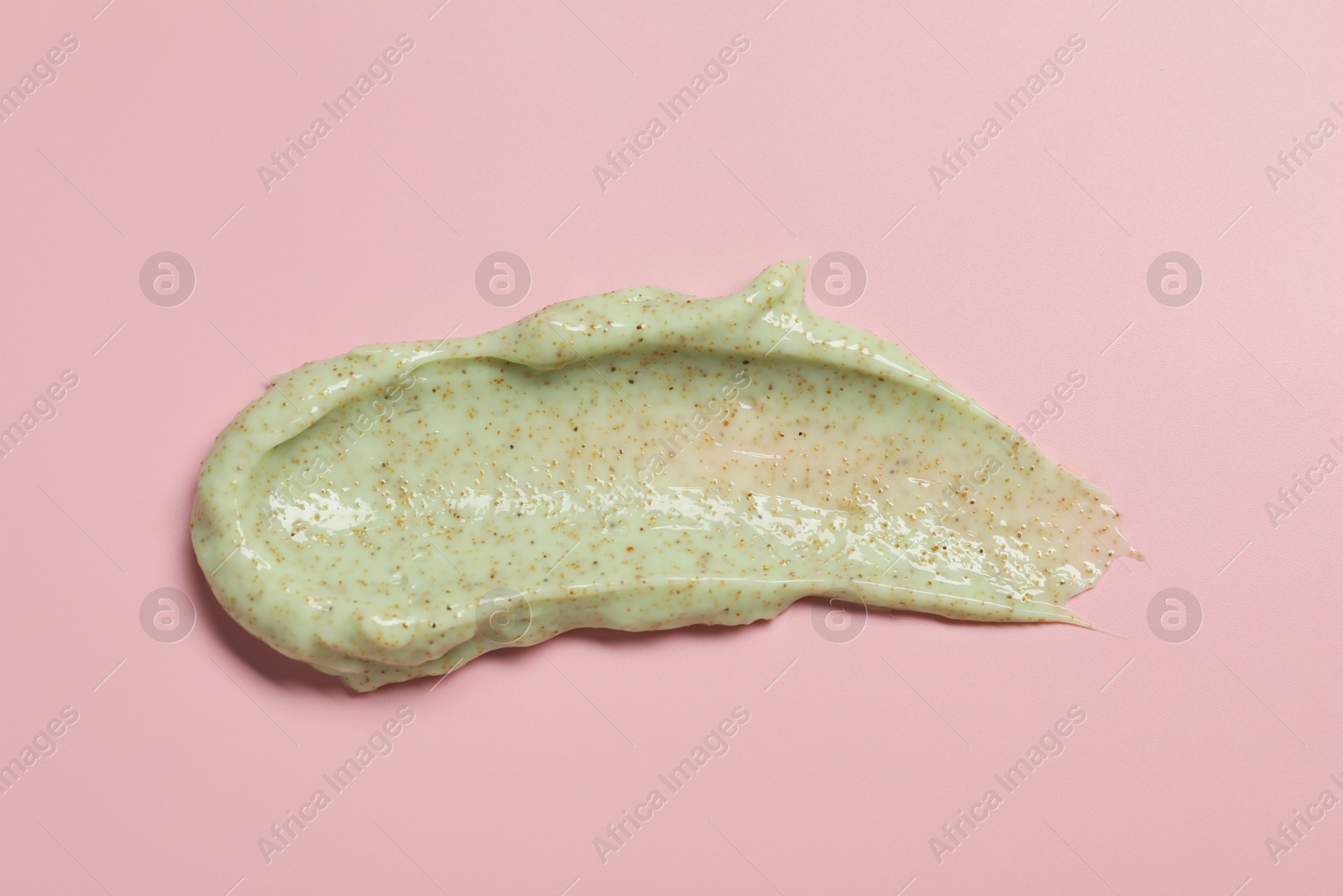 Photo of Smear of body scrub on pink background, top view