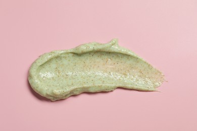 Smear of body scrub on pink background, top view