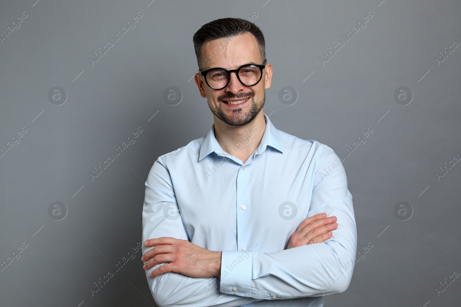 Photo of Portrait of handsome middle aged man on grey background