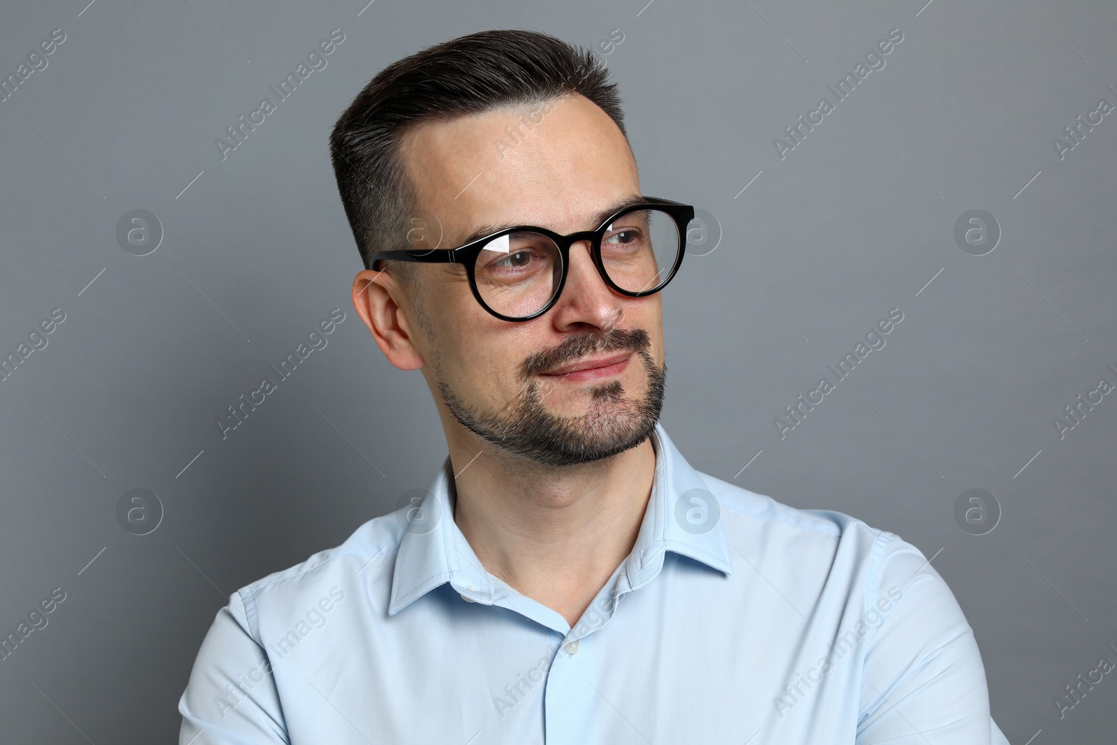 Photo of Portrait of handsome middle aged man on grey background