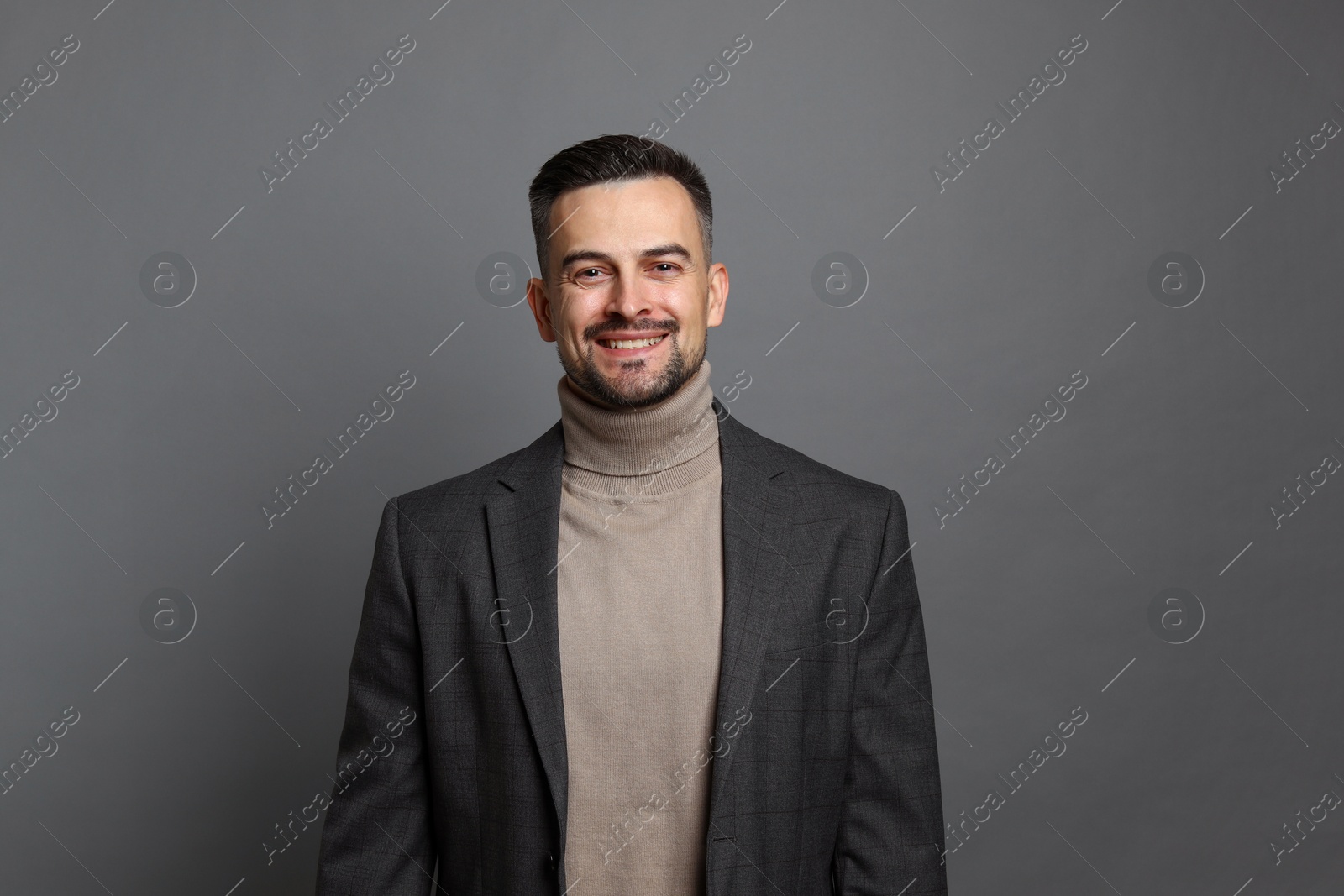 Photo of Portrait of handsome middle aged man on grey background