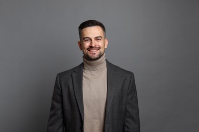 Photo of Portrait of handsome middle aged man on grey background