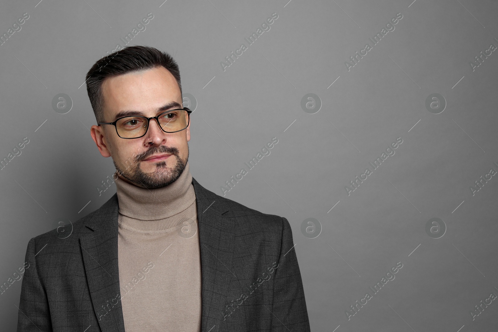 Photo of Portrait of handsome middle aged man on grey background, space for text