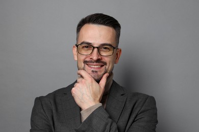 Photo of Portrait of handsome middle aged man on grey background