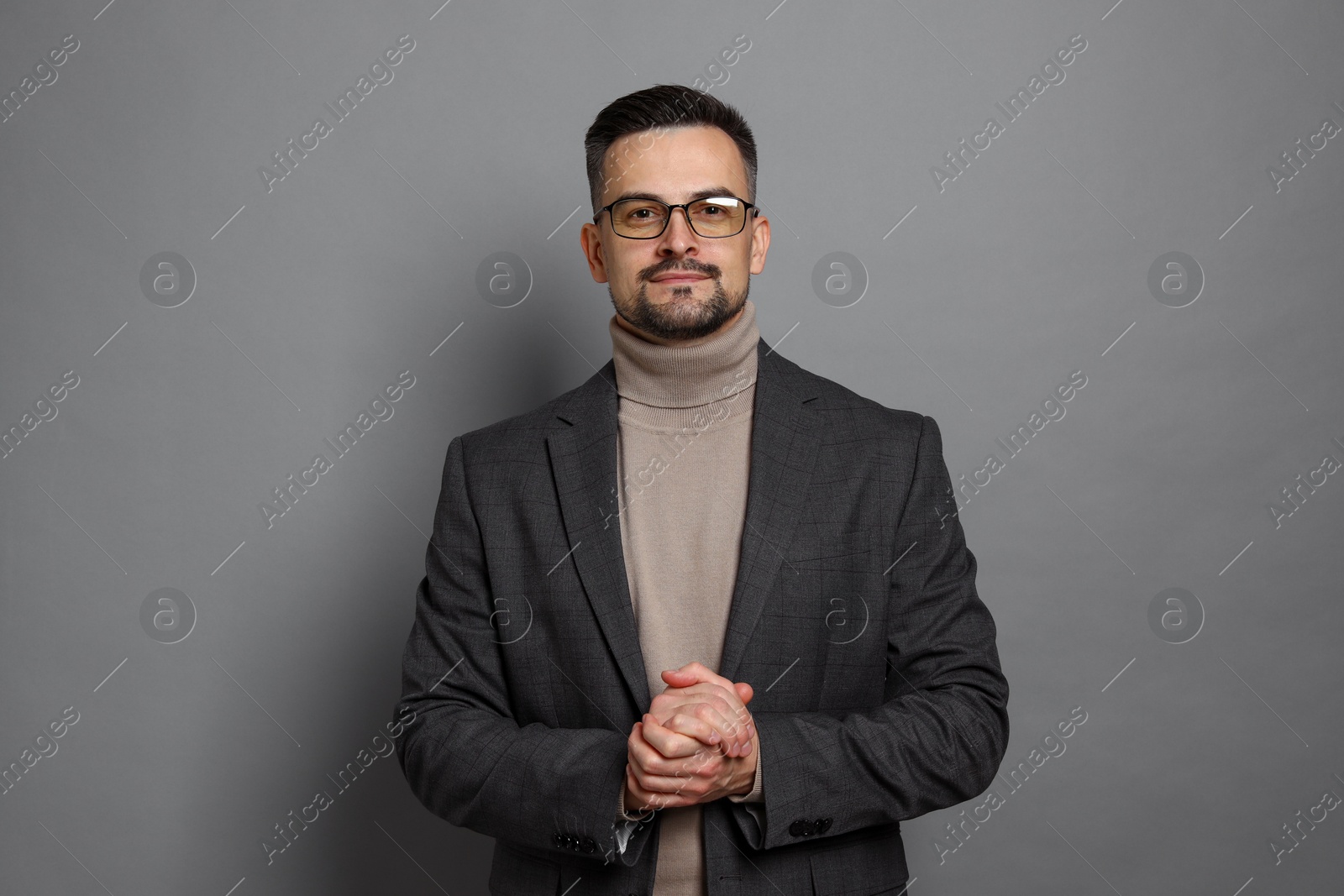 Photo of Portrait of handsome middle aged man on grey background