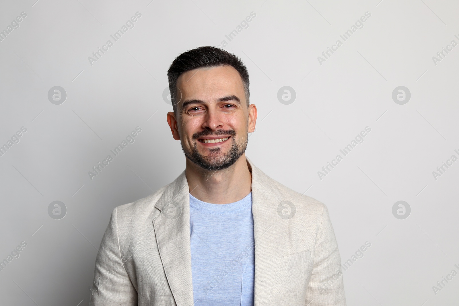 Photo of Portrait of handsome middle aged man on light background