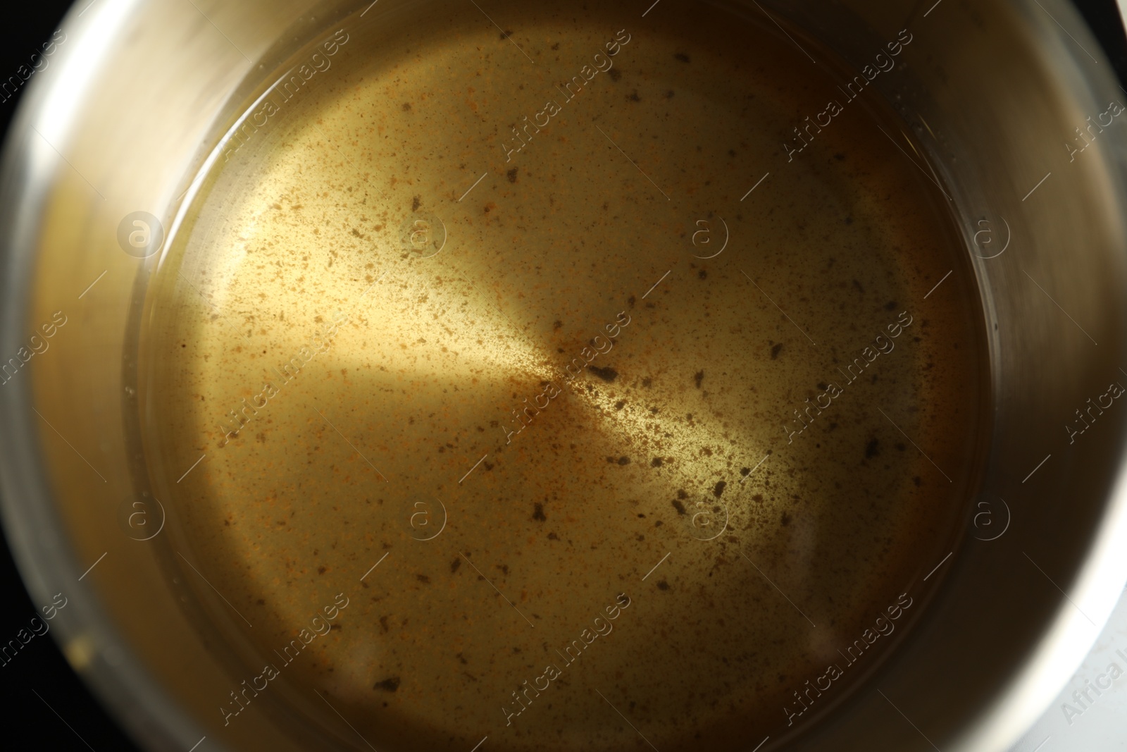 Photo of Used cooking oil in saute pan, closeup