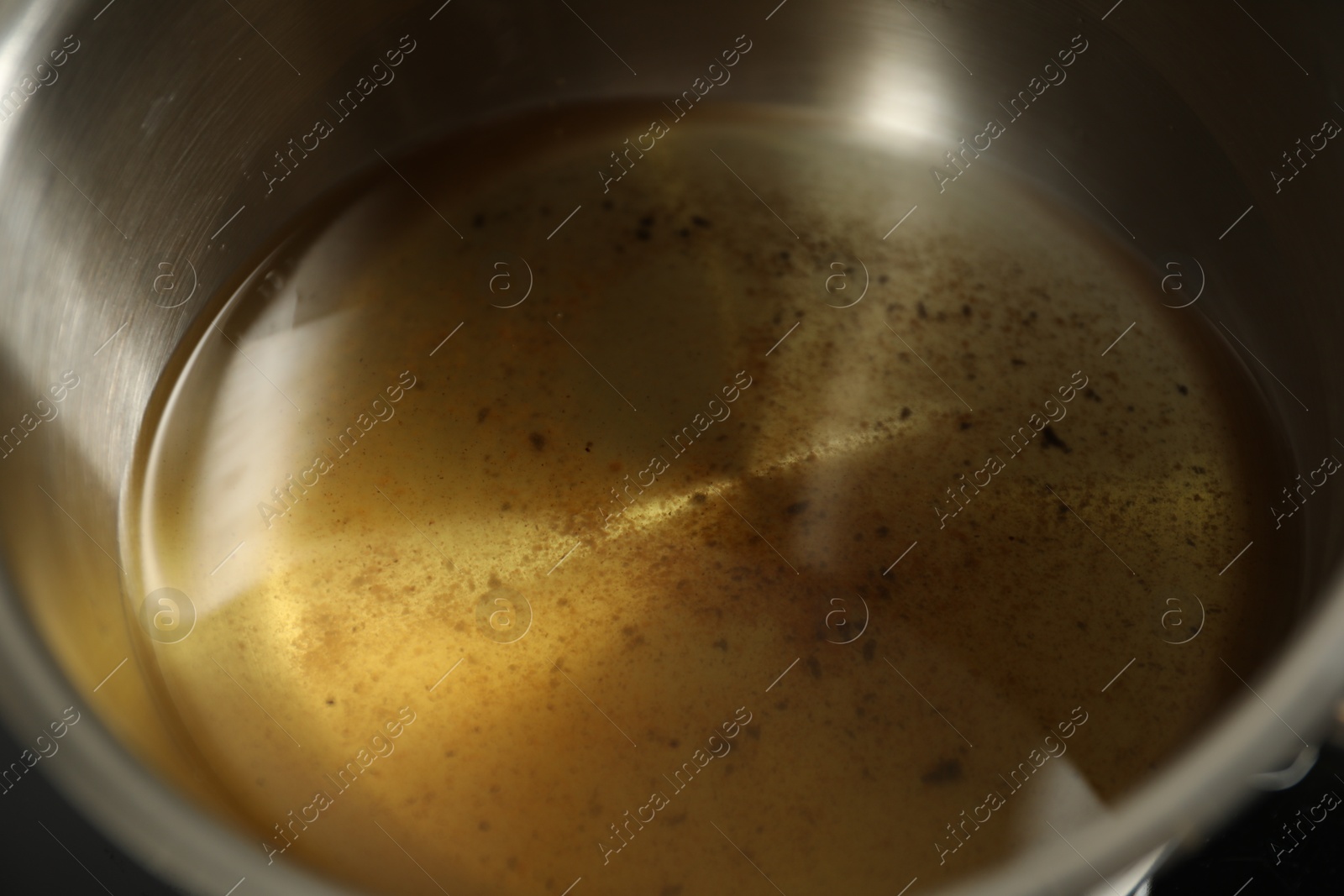 Photo of Used cooking oil in saute pan, closeup