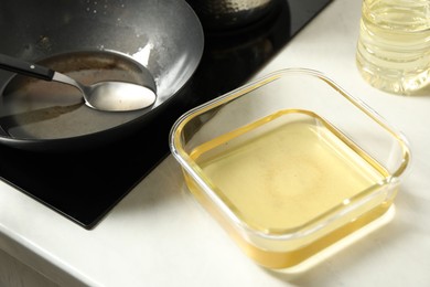 Photo of Used cooking oil in kitchen, closeup view