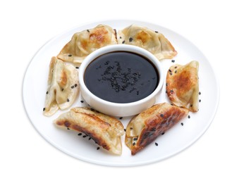 Delicious fried gyoza dumplings with soy sauce isolated on white