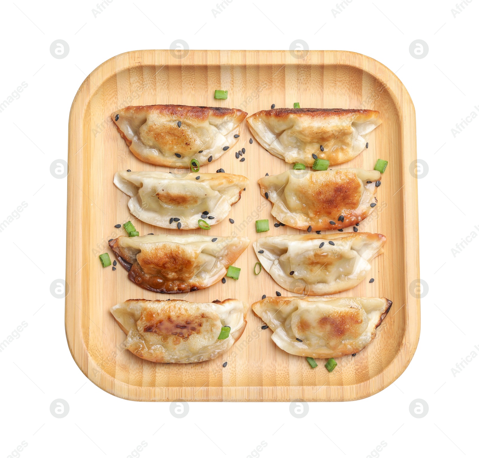 Photo of Delicious fried gyoza dumplings with green onions and sesame seeds isolated on white, top view