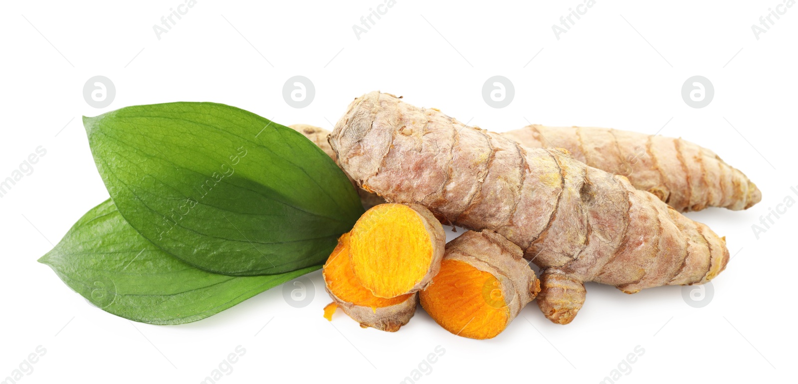 Photo of Tumeric rhizomes with leaves isolated on white