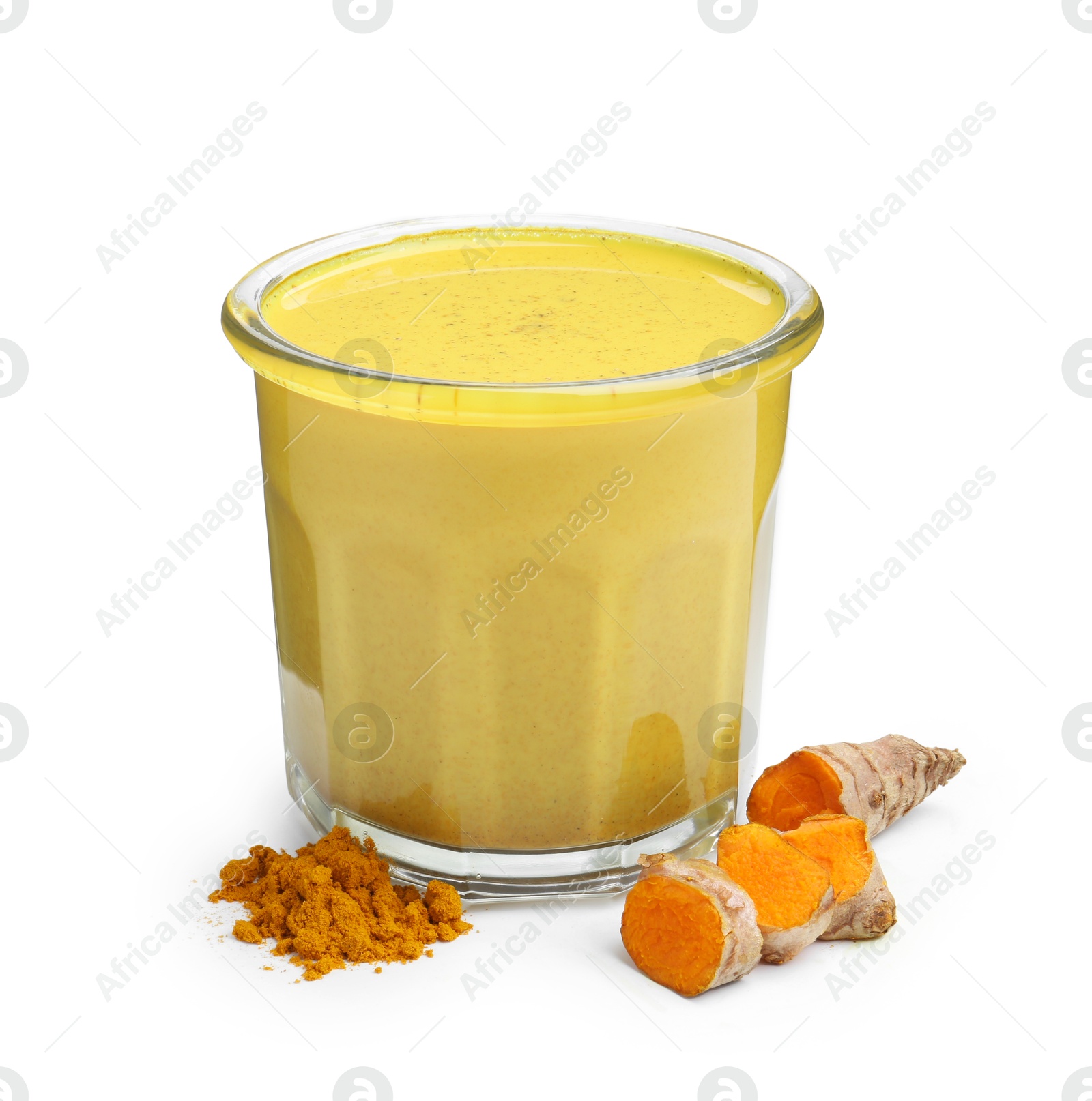 Photo of Delicious turmeric latte in glass, powder and roots isolated on white