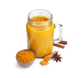 Photo of Delicious turmeric latte in mason jar and spices isolated on white