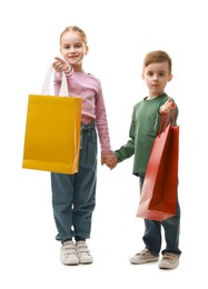 Photo of Cute little friends with shopping bags holding hands on white background