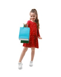 Photo of Cute little girl with shopping bags on white background