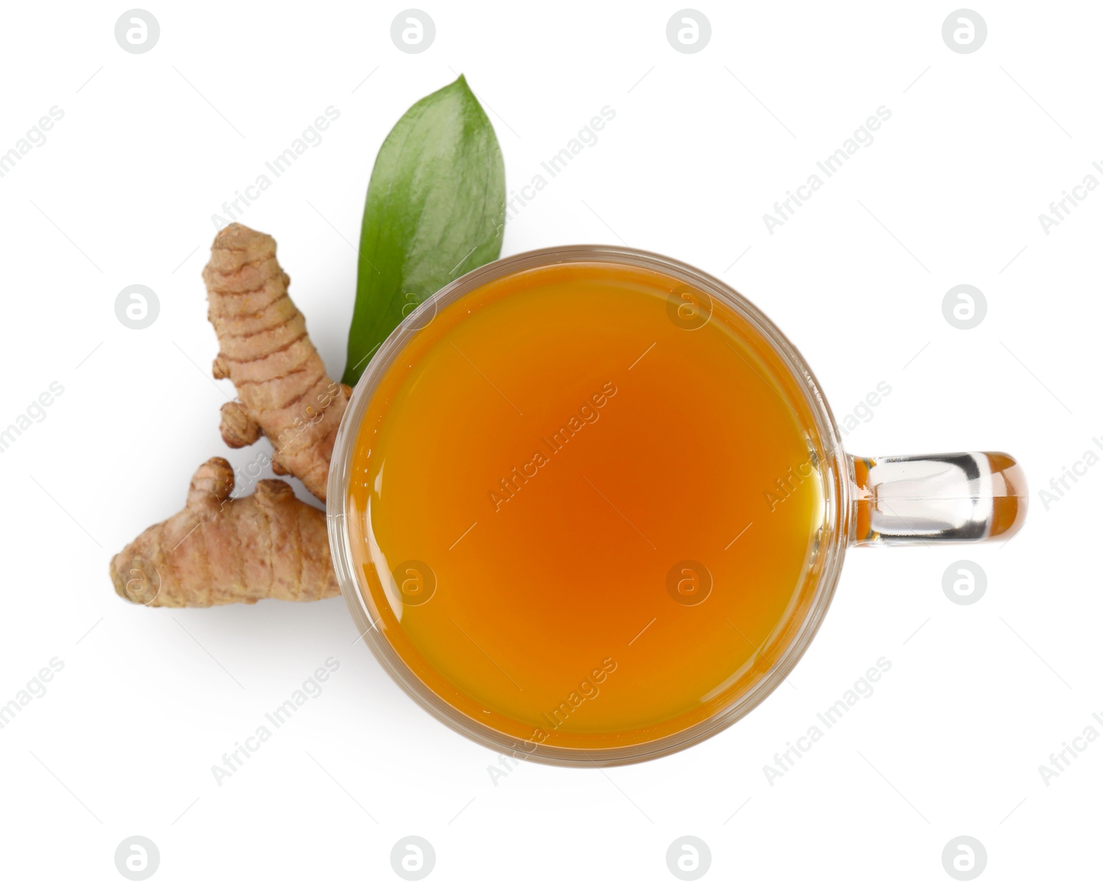 Photo of Aromatic turmeric tea in glass cup, roots and green leaf isolated on white, top view