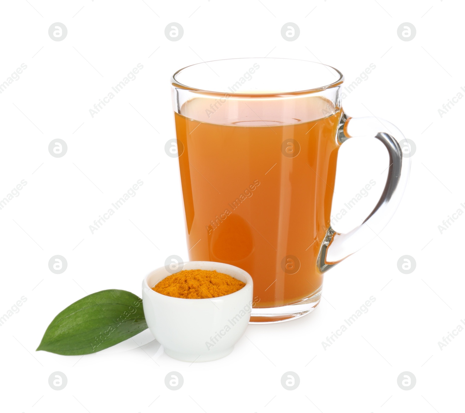 Photo of Aromatic turmeric tea in glass cup, powder and green leaf isolated on white