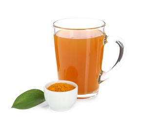 Photo of Aromatic turmeric tea in glass cup, powder and green leaf isolated on white