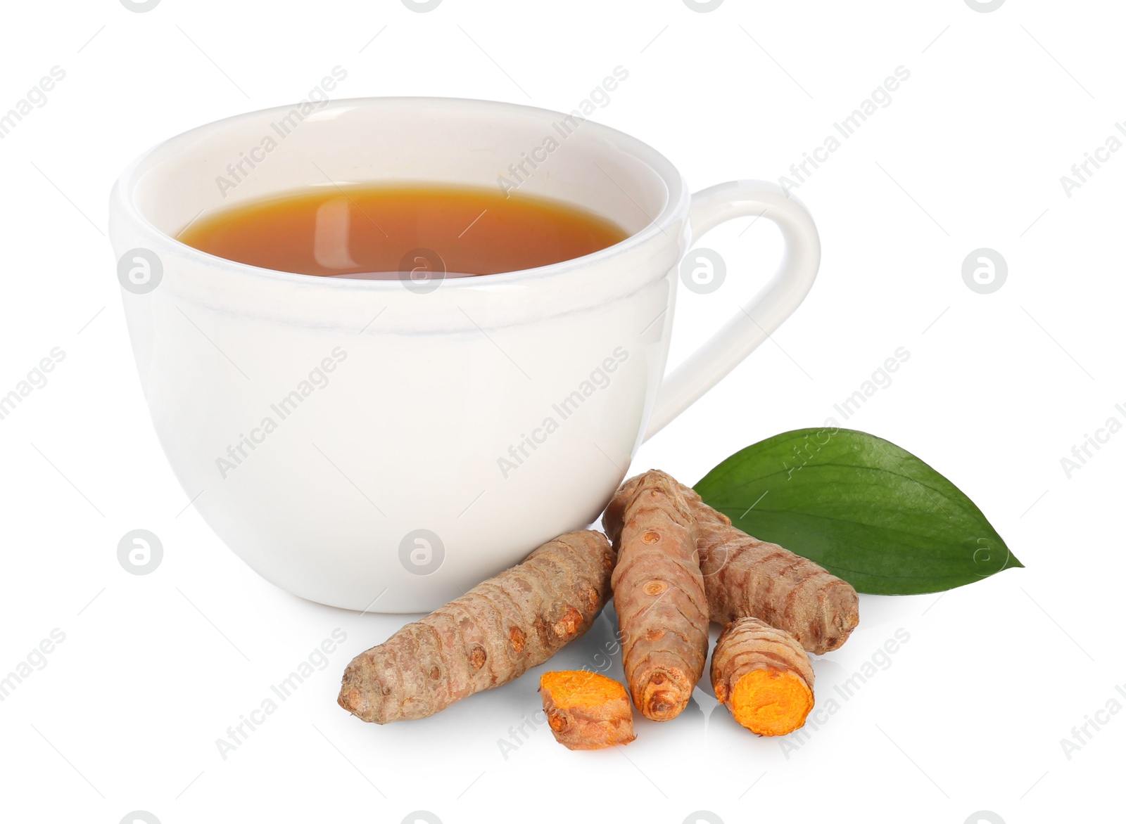 Photo of Aromatic turmeric tea in cup, roots and green leaf isolated on white