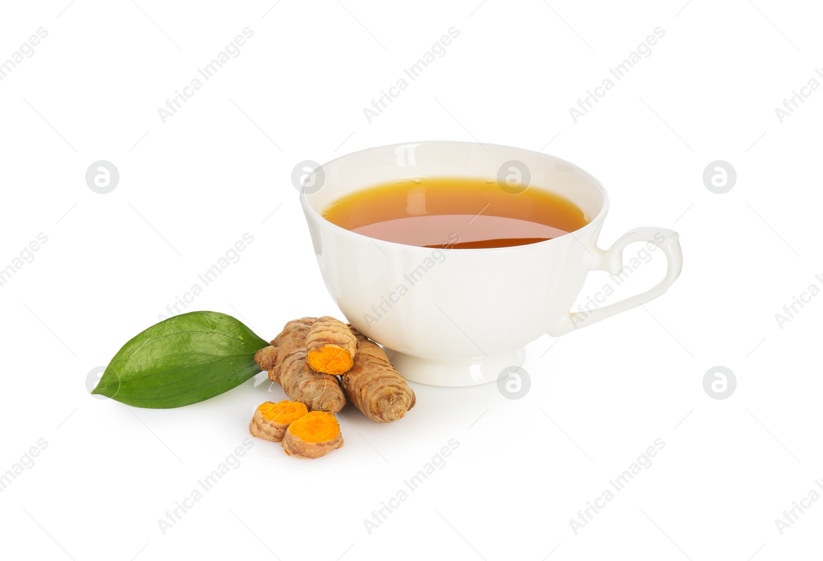 Photo of Aromatic turmeric tea in cup, roots and green leaf isolated on white