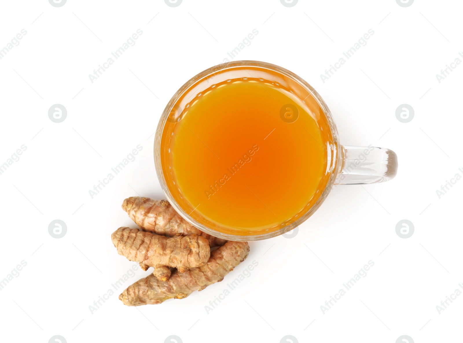 Photo of Aromatic turmeric tea in glass cup and roots isolated on white, top view