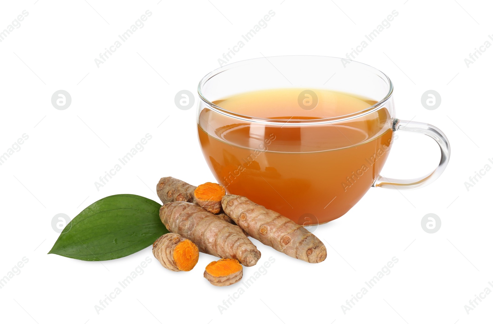 Photo of Aromatic turmeric tea in glass cup, roots and green leaf isolated on white