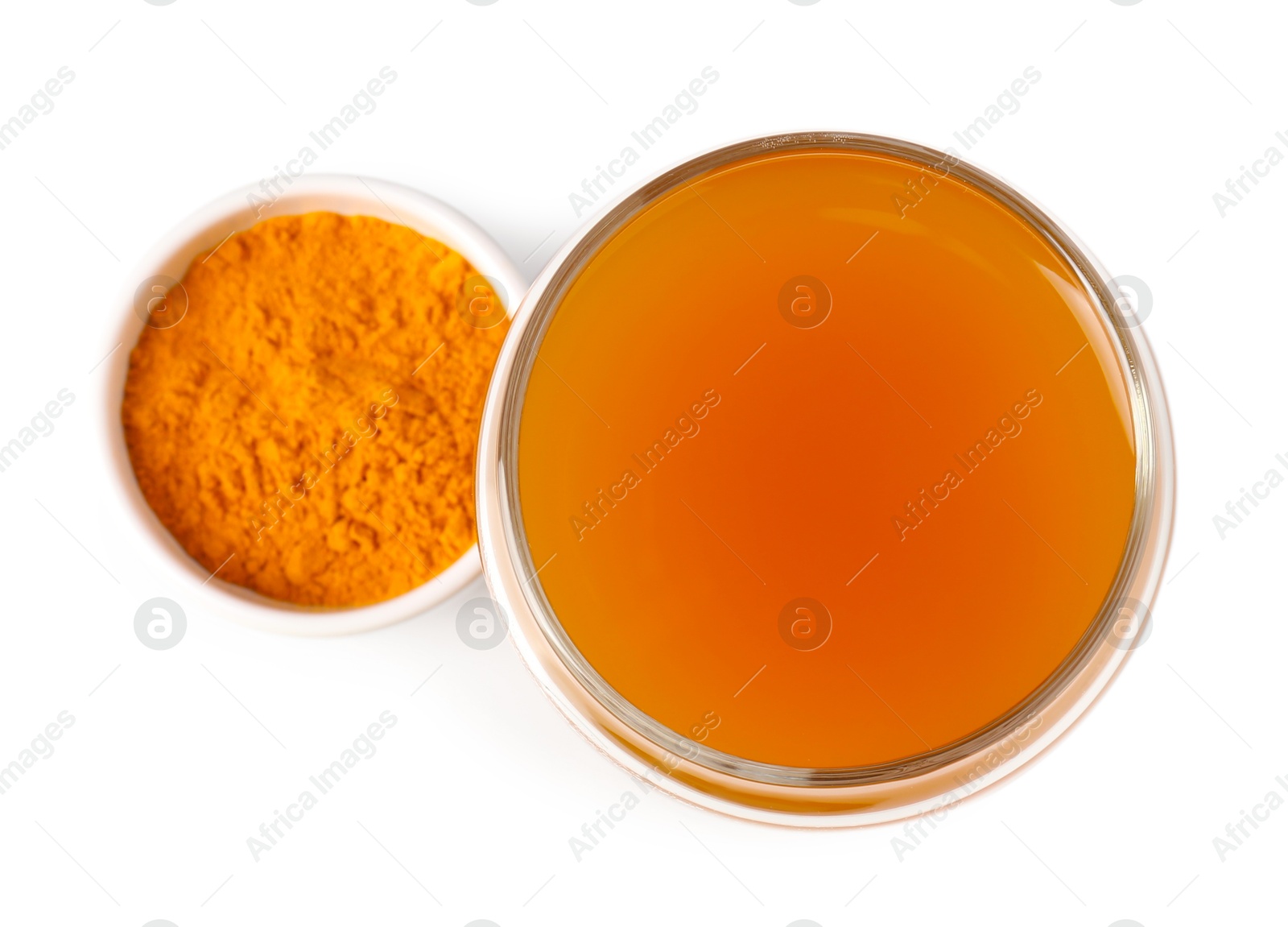 Photo of Aromatic turmeric tea in glass and powder isolated on white, top view